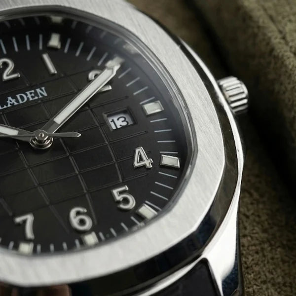 VEY 013 black textured grid dial close-up — luminous hands, date display, steel bezel